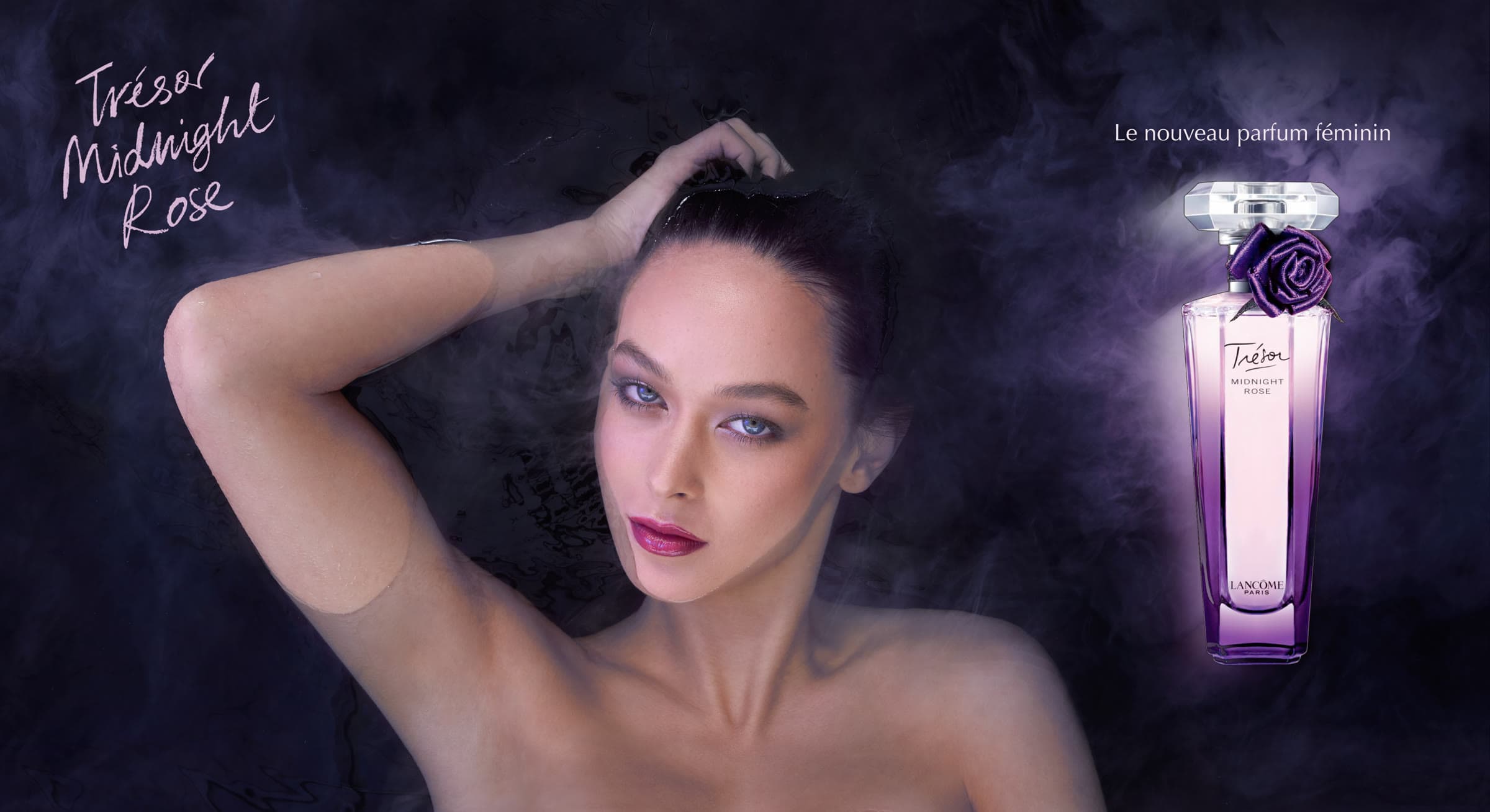 A beauty campaign plate: a woman in dark water beside a Lancôme Trésor Midnight Rosé perfume bottle